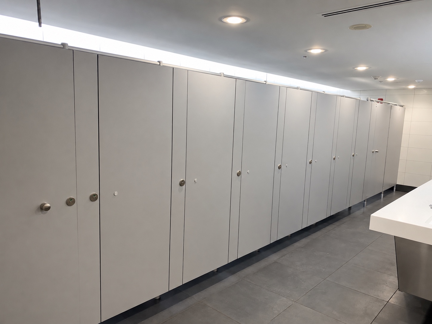 Long bank of restroom partitions at Miami International Airport