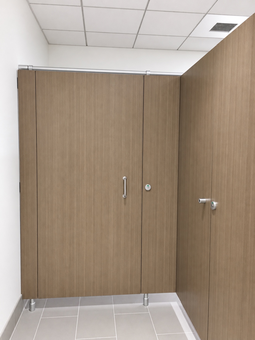 PRIVACY 2000 restroom partition installation with a clean wood-look front